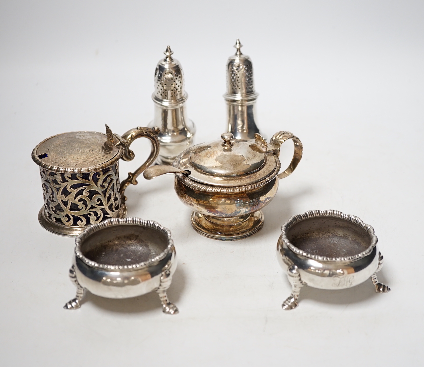 A collection of small silver items to include a pair of Georgian cauldron salts, two mustard pots including London, 1828 and London, 1850 and two George II pepperettes, London, 1749 and 1749, one a.f.